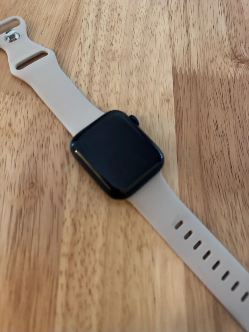 Apple Smartwatch with Light Beige Silicone Band and Black Face